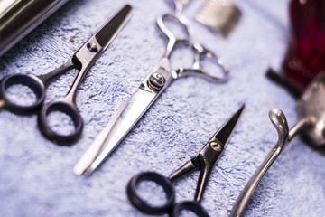 Close up. Barbershop tools placed on a blue towel. Scissors placed neatly. Focus on scissors.