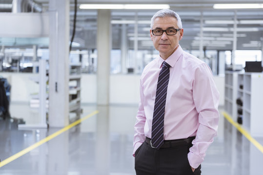 Portrait of a manager on shop floor of a factory