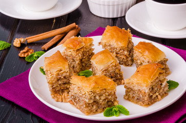 Homemade baklava with filo dough and walnuts in honey and sugar syrup
