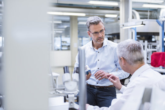 Two managers discussing product in company