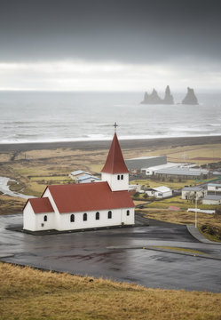 Iceland, Vik, church and stone trolls in the background