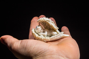 holding a angel figurine in hands