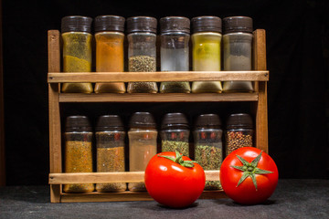 Two fresh red tomatoes with spices mix