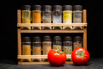 Two fresh red tomatoes with spices mix