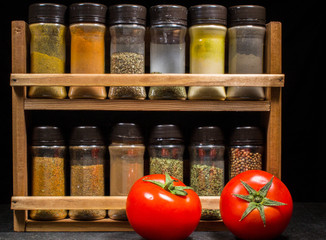 Two fresh red tomatoes with spices mix
