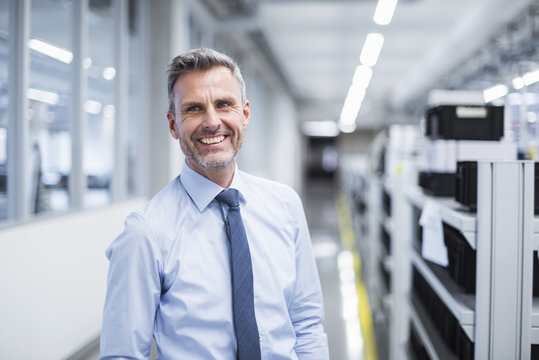 Portrait of a manager on the shop floor of a factory
