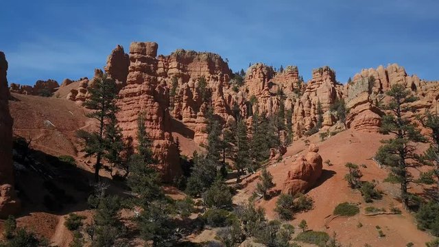 Aerial Bryce Canyon Red Canyon landscape climb forward. Red Canyon near the Park within Dixie National Forest in southwest Utah. Geological structures hoodoos formation weathering and water erosion.