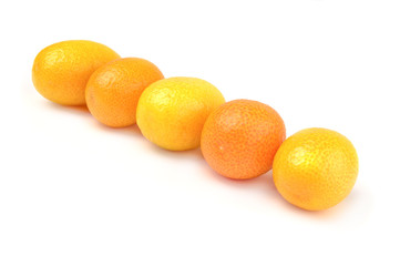 Group of ripe kumquat on plate over white background