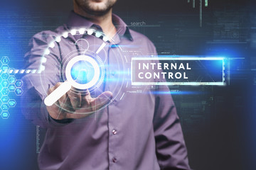 Business, Technology, Internet and network concept. Young businessman working on a virtual screen of the future and sees the inscription: Internal control