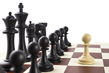 Chess business concept, leader & success. White pawn in front of black figures on chess board
