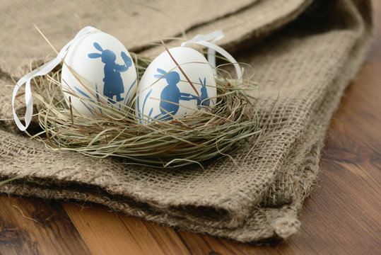 easter eggs in a nest on wooden background