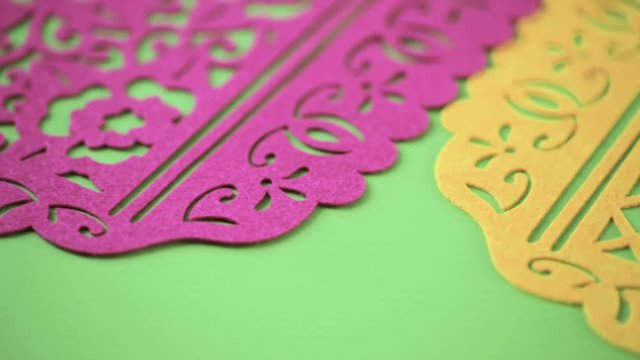 Traditional Mexican papel picado paper banner on a wood background