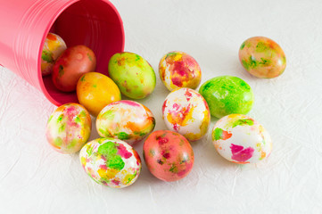 Painted Easter eggs falling out of can