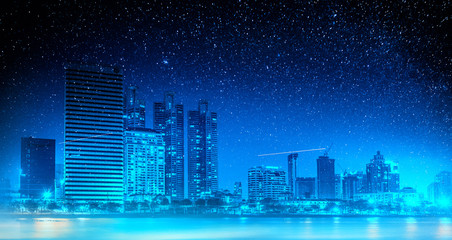 Obraz na płótnie Canvas Double exposure night cityscape with colorful Milky Way