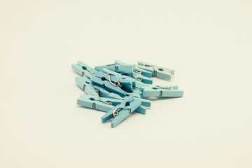 A set of blue wooden clothespins on white background