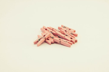 A set of pink wooden clothespins on white background