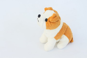 White dog doll with brown ears on white background.