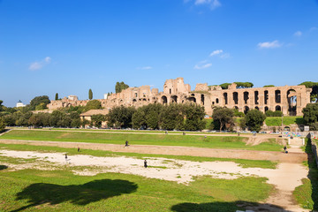 Fototapeta na wymiar Rome, Italy. The Large Circus (Circus Maximus) in the background of the ruins of the imperial palaces on Palatine Hill.