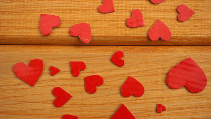 many red hearts on a wooden background