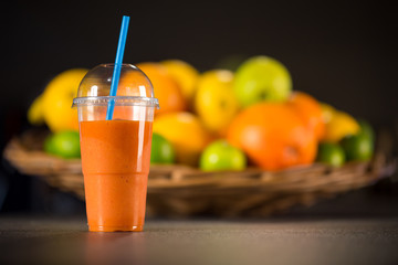 Glass of fresh smoothie made from oranges, carrots and ginger