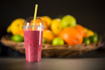 Fresh red smoothie with fruits on the background