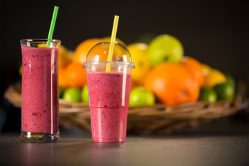 Fresh red smoothie with fruits on the background