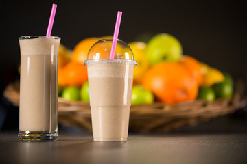 Fresh banana yogurt smoothie with fruits on a black background