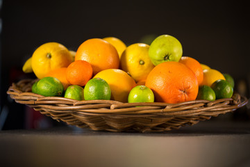 Wooden basket full of fresh fruits for lemonade and smoothies