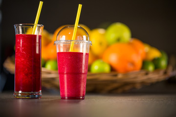 Fresh red smoothie with fruits on the background