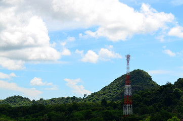 Telecommunication tower against blue sky and mountain