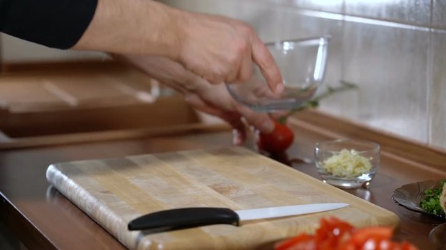 Man mixes ingredients for cooking bruschetta