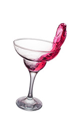 Splash in glass of a pink alcoholic cocktail drink