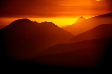 A beautiful, colorful, abstract mountain landscape in a red tonality. Decorative, artistic look.