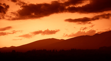 A beautiful, colorful, abstract mountain landscape in a red tonality. Decorative, artistic look.