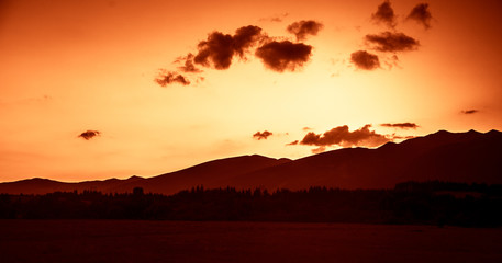 Fototapeta premium A beautiful, colorful, abstract mountain landscape in a red tonality. Decorative, artistic look.