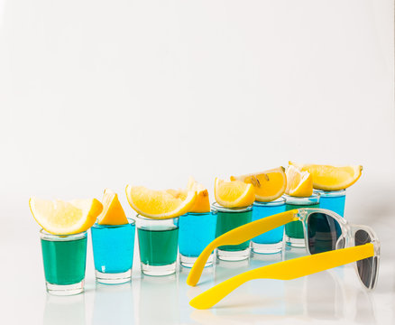 Glasses With Blue And Green Kamikaze, Glamorous Drinks, Mixed Drink Poured Into Shot Glasses, Sunglasses