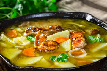 Soap with meat, potato and carrots in the pan