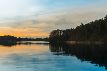 Sunset silhouetting trees on a lake