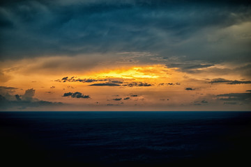 abstract dark texture clouds and beautiful sunset light in storm over ocean