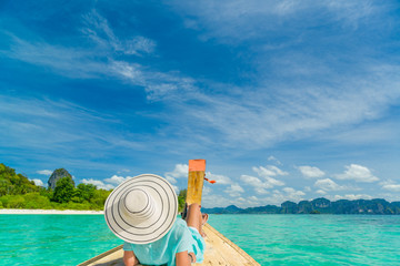 Fototapeta na wymiar Young woman traveler on longtail boat trip at island hopping