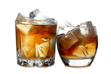 Whiskey and ice in glass on white background