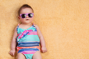 Newborn baby in beachwear