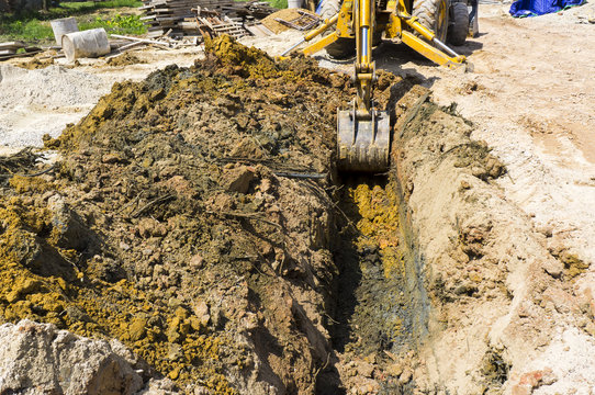 Digging hole for septic tank installation.