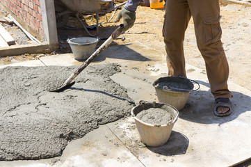 Mix a cement at construction site, tools and sand.