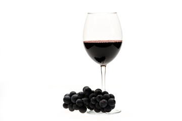 Glass of red wine and grapes isolated on white background