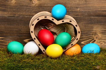 Fototapeta na wymiar easter colorful eggs in wooden heart box