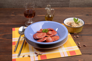 red radicchio ravioli with mushroom cream