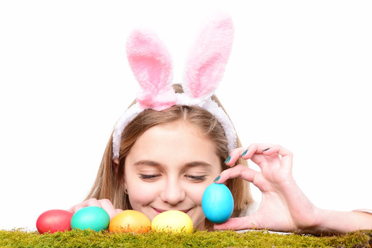 happy easter girl in bunny ears with colorful painted eggs
