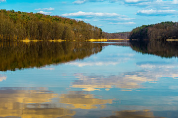 Sunset clouds reflected in a tranquil lake