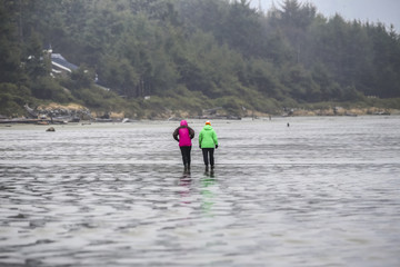 People walking along beach in rain